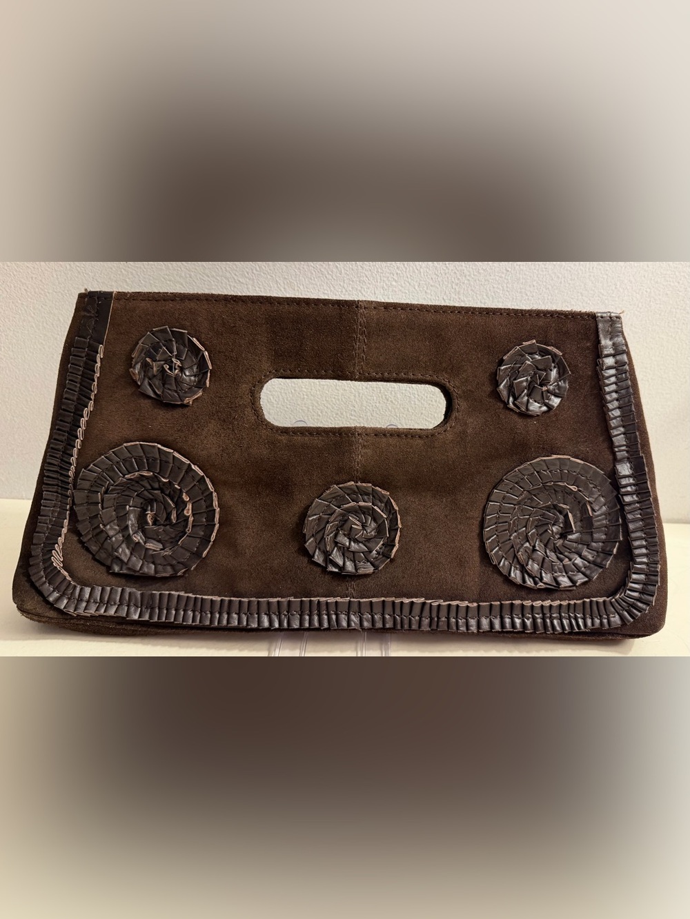Vintage brown suede clutch with 3-D spiral toolings and a cut-out handle.